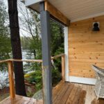 Wooden deck overlooking a serene lake.