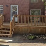 Backyard wooden deck with railing
